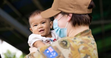 Australian Army officer Captain Sarah Kelly, public affairs officer, holds a child from the local community at Macarascas Elementary School, Palawan, Philippines. Story by Captain Sarah Kelly. Photo by Corporal Brandon Grey.