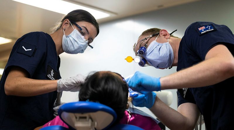 Air Force Dentist Flight Lieutenant Jack O'Neill (right) and Dental Assistant Leading Aircraftwoman Ocean Mitchell perform a dental procedure onboard United States Hospital Ship USNS Mercy during Pacific Partnership 2022 in Palawan, Philippines. Story by Captain Sarah Kelly. Photo by Corporal Brandon Grey.