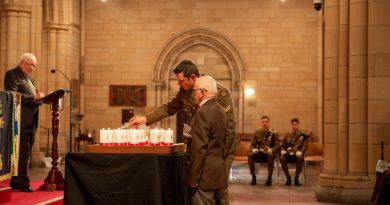 Soldiers of 6RAR and members of the Long Tan Veterans Association light a candle during the Battle of Long Tan service held at St John's Cathedral. Story and photo by Captain Cody Tsaousis.