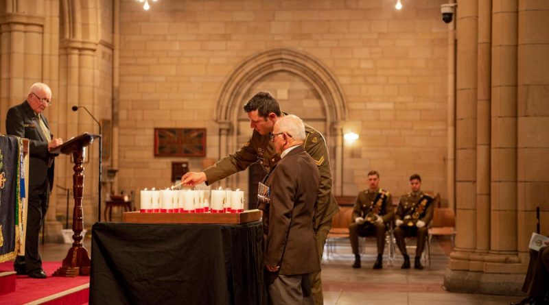 Soldiers of 6RAR and members of the Long Tan Veterans Association light a candle during the Battle of Long Tan service held at St John's Cathedral. Story and photo by Captain Cody Tsaousis.