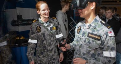 Lieutenant Commander Siobhan Sturdy guides Midshipman Kane Kasemchainan through a virtual training demonstrator at the Australian Defence Force Academy open day. Story by Lieutenant Yvette Goldberg. Photo by Petty Officer Bradley Darvill.