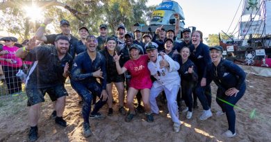 Leanne Caban (centre) with the captain, Stephen Smith, and crew of HMAS Courage after participating in the Battle of the Boats at the Henley on Todd Regatta in Alice Springs. Story by Leading Seaman Jonathan Rendell. Photo by Leading Seaman Shane Cameron.