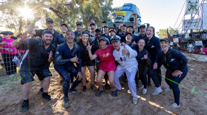 Leanne Caban (centre) with the captain, Stephen Smith, and crew of HMAS Courage after participating in the Battle of the Boats at the Henley on Todd Regatta in Alice Springs. Story by Leading Seaman Jonathan Rendell. Photo by Leading Seaman Shane Cameron.