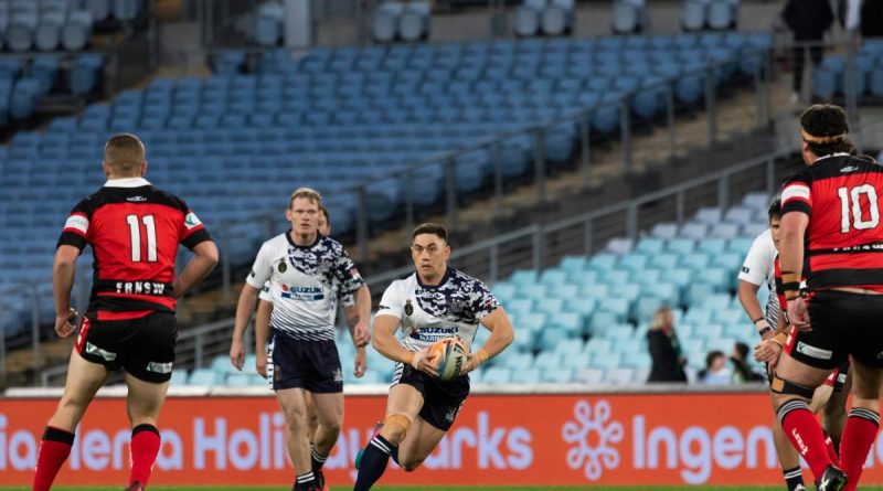 Able Seaman Manuel Grundy-Quay runs the ball as the Navy Tridents play Fire and Rescue NSW in the Community Cup Rugby League game at Accor Stadium in Sydney. Photo by Leading Seaman Daniel Goodman.