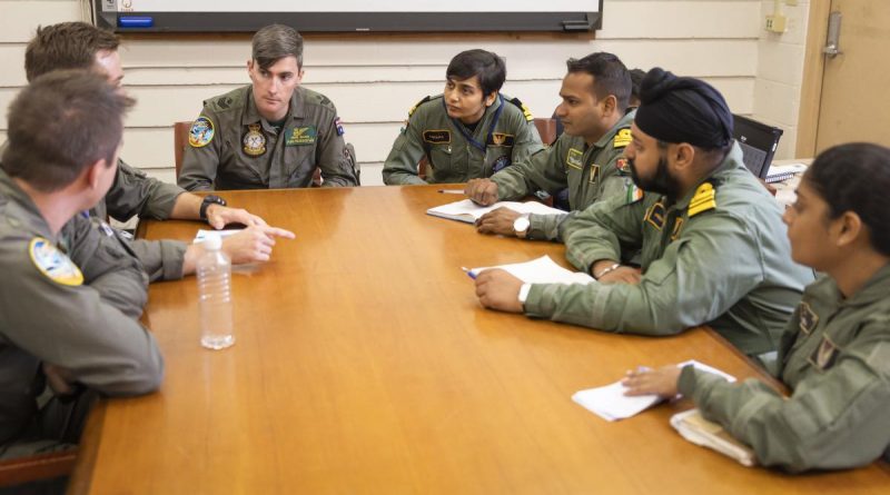 Members of the Royal Australian Air Force and Indian Navy P-8 flight teams chat during a combined crew training discussion at Joint Base Pearl Harbor-Hickam during Exercise Rim of the Pacific (RIMPAC) 2022. Story and photo by Leading Seaman Kylie Jagiello.