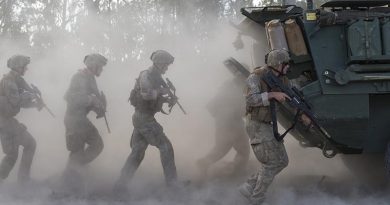 New Zealand Army infantry 'indian file' behind a moving Light Armoured Vehicle. NZDF file photo.