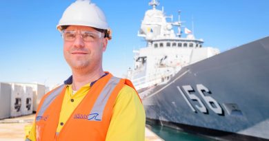 Phil Clifford from the Defence Industry Pathways Program stands in front of HMAS Toowoomba, the seventh Anzac-class frigate of the Royal Australian Navy. Story by Phillip Morton. Photo by Simon Casson.