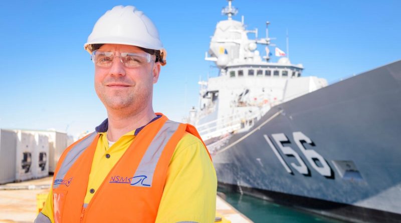 Phil Clifford from the Defence Industry Pathways Program stands in front of HMAS Toowoomba, the seventh Anzac-class frigate of the Royal Australian Navy. Story by Phillip Morton. Photo by Simon Casson.