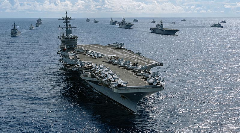 US Navy aircraft carrier USS Abraham Lincoln leads a fleet of multi-national ships in formation during Exercise Rim of the Pacific (RIMPAC) 2022. Photo by Corporal Djalma Vuong-De Ramos.