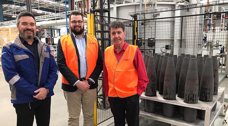 Rheinmetall NIOA Munitions project manager Jeff Crabtree, left, with RNM director Jackson Nioa and Member for Maryborough Bruce Saunders and the first projectiles to come out of the $60m shell forging plant in Maryborough, Queensland. Supplied.