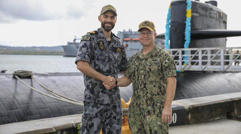 Navy submariner Lieutenant Commander Daniel McCall, left, and US Navy Submarine Squadron 15 Commanding Officer Captain Bret Grabbe stand in front of USS Key West, alongside US Naval Base Guam. Story by Lieutenant Sarah Rohweder. Photo by Mass Communication Specialist 3rd Class Naomi Johnson.