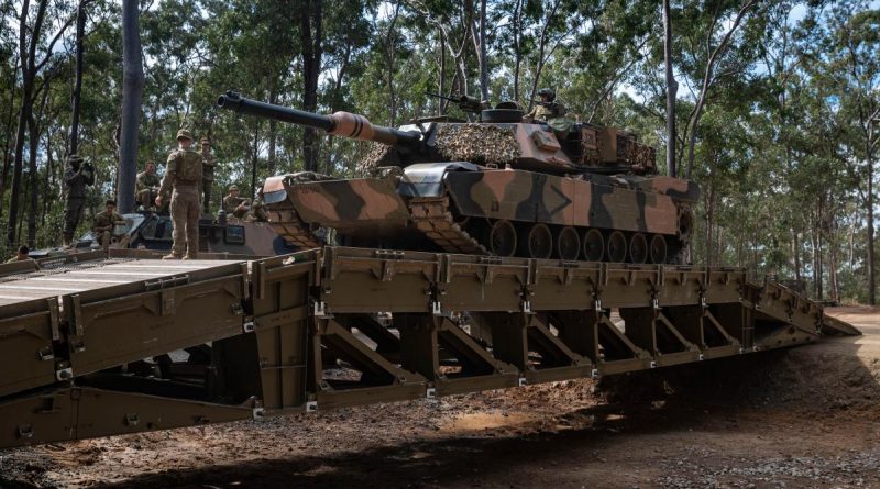Lance Corporal Jesse McMah, from 2nd/14th Light Horse Regiment (Queensland Mounted Infantry) guides an M1A1 Abrams main battle tank over a medium girder bridge during training at Gallipoli Barracks, Brisbane. Story by Captain Cody Tsaousis. Photo by Corporal Nicole Dorrett.