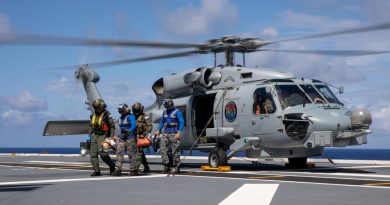 Royal Australian Navy medical officers Commander Robert Turner and Lieutenant Cody Nash transfer a simulated casualty from a MH-60R Seahawk during a training exercise on board HMAS Canberra. Story by Lieutenant Nancy Cotton. Photo by Petty Officer Christopher Szumlanski.