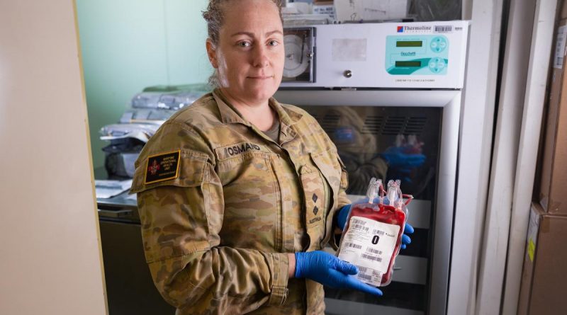 Lieutenant Melissa Osmand inspects packed red blood cells stored in a dedicated blood fridge on board HMAS Canberra. Story by Lieutenant Nancy Cotton. Photo by Leading Seaman Matthew Lyall.