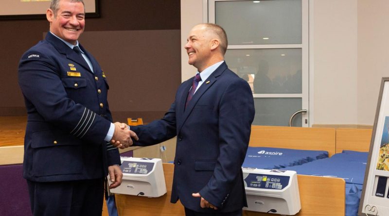 Senior ADF Officer at RAAF Base Amberley Group Captain Iain Carty and Bruce McGowan stand in front of the two cuddle beds presented to the palliative care unit of Warwick Hospital. Story by Flying Officer Greg Hinks. Photo by Leading Aircraftman Stewart Gould.