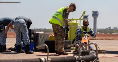 RAAF Leading Aircraftman Thomas Clarke-Kelly, right, and UK Royal Air Force Air Specialist Class One Declan McTrusty, centre, work together to refuel a Republic of Singapore Air Force F-15SG Eagle aircraft. Story by Flying Officer Connor Bellhouse. Photo by Leading Aircraftman Chris Tsakisiris.