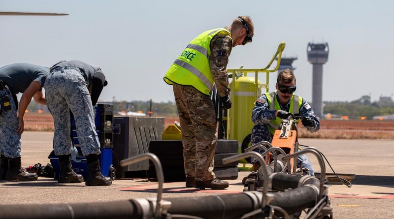 RAAF Leading Aircraftman Thomas Clarke-Kelly, right, and UK Royal Air Force Air Specialist Class One Declan McTrusty, centre, work together to refuel a Republic of Singapore Air Force F-15SG Eagle aircraft. Story by Flying Officer Connor Bellhouse. Photo by Leading Aircraftman Chris Tsakisiris.