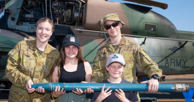 Craftsman Amber Toner, left, and Craftsman Cameron Powell, from 1st Aviation Regiment, with Emily and Oliver Taaffe and a 70mm rocket from the Tiger helicopter during the Exercise Pitch Black open day at RAAF Base Darwin. Story by Flight Lieutenant Jessica Winnall. Photo by Corporal Kylie Gibson.