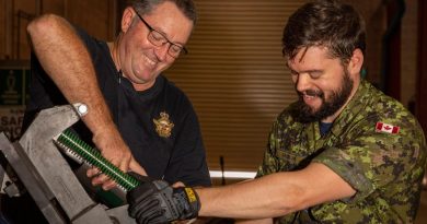 RAAF ground support equipment technician Corporal James Harding, left, and Royal Canadian Air Force aircraft arrestor systems technician Corporal Evan Barbeau maintain a BAK arrestor arm. Flight Lieutenant Jessica Winnall. Photo by Leading Aircraftwoman Annika Smit.