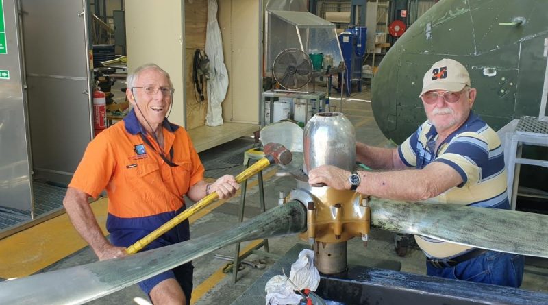 Warrant Officer Kevin ‘Skeet’ Parker, left, removing the dome nut from a propeller in the paint shop at the RAAF Townsville Aviation Heritage Centre. Story by Flight Lieutenant Karyn Markwell. Photo by Flight Sergeant Michael Hartley.