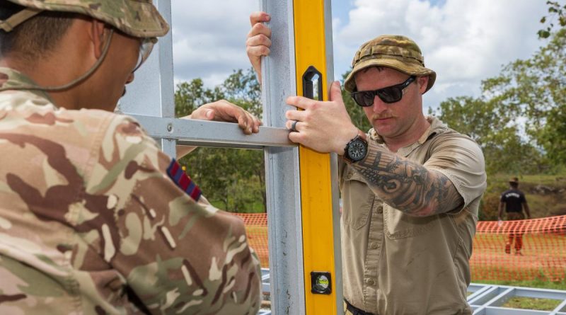 Sapper Cameron Turner, right, from the 6th Engineer Support Regiment, checks the level of a frame on-site during Exercise Puk Puk at Goldie River Training Depot in Papua New Guinea. Story by Major Jesse Robilliard. Photo by Sergeant Nunu Campos.