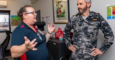 Tracey Small, left, gives Lieutenant Roderick Thiele a tour of the Darwin harbour control office during Exercise Kakdau 2022. Story by Lieutenant George Cross. Photo by Leading Seaman Shane Cameron.