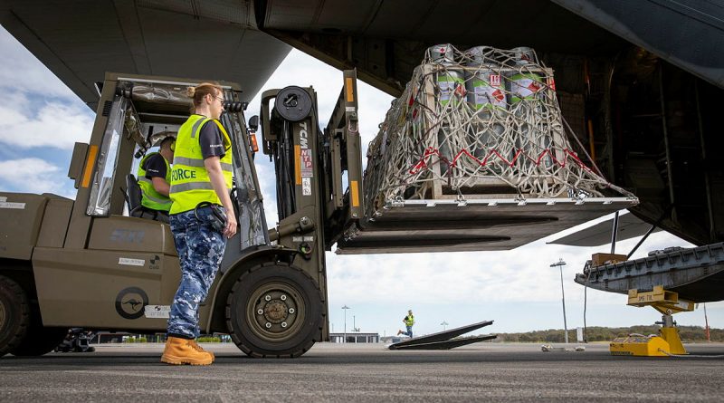 Air Force mobile air load team aviators from No 22 Squadron load liquefied petroleum gas tanks into a C-130J Hercules aircraft at Port Macquarie, New South Wales. Story by Flight Lieutenant Bronwyn Marchant. Photo by Leading Aircraftman Chris Tsakisiris.