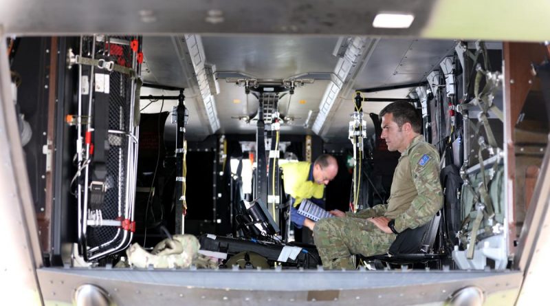 Major Waldo Britz prepares test equipment on a 5th Aviation Regiment MRH90 Taipan helicopter at RAAF Base Townsville. Story by Lieutenant Akhil Kambil and Captain Carolyn Barnett. Photo by Corporal Lisa Sherman.