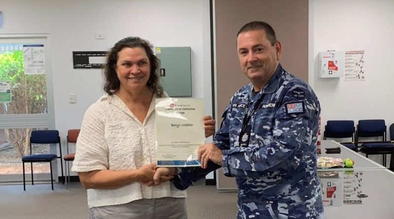 Defence civilian Beryl Webber receives her graduation certificate after successfully completing the Certificate II in Security Operations course at RAAF Base Tindal, Northern Territory. Story by Sarah-Kate Melehan.