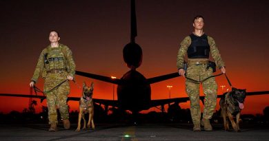 RAAF military-working-dog handler Leading Aircraftwoman Brooke Hitchinson with her dog, Karma, and Royal New Zealand Air Force counterpart Leading Aircraftman Byron Buys with Kaiser, on the flightline at RAAF Base Darwin during Exercise Pitch Black 2022. Photo by Leading Aircraftwoman Kate Czerny.