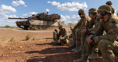 Australian soldiers watch a 1st Armoured Regiment, Royal Australian Armoured Corps, M1 Abrams tank drive past during a live-fire demonstration on Exercise Predators Run at Mount Bundey Training Area, NT. Photo by Corporal Jacob Joseph.
