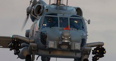 An embarked MH-60 Romeo helicopter prepares to land onboard HMAS Adelaide at sunset during First Of Class Flight Trials. Photo by Able Seaman Jarrod Mulvihill.