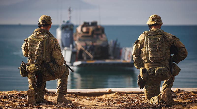 Australian Army soldiers from 10 Force Support Battalion await the arrival of a Boxer Combat Reconnaissance Vehicle during Exercise Sea Raider 2022 at Cowley Beach, Queensland. Photo by Corporal Cameron Pegg.