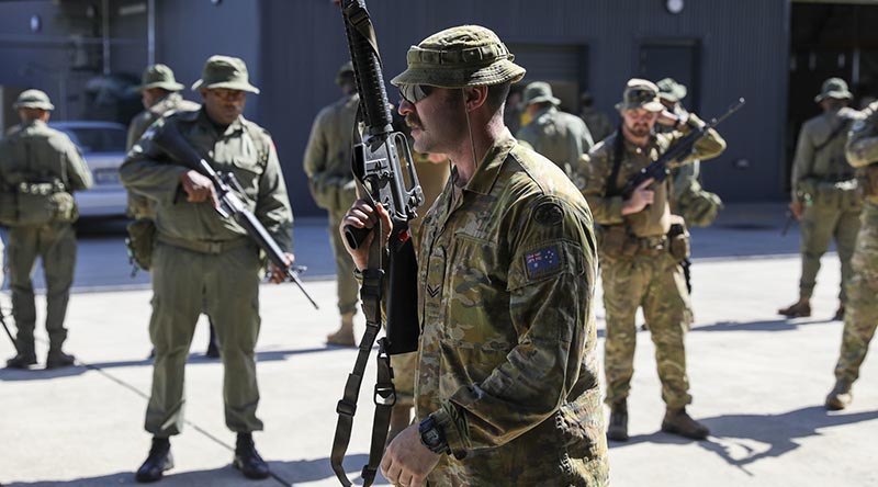 Australian Corporal Louis Carbery, an infantry soldier with 8/9RAR, discusses how his army clears hallways and intersections at Blackrock Training Camp, Fiji, during Exercise Cartwheel. Story and photo by US Army Sergeant Brian D. Jones, 343rd Mobile Public Affairs Detachment. 