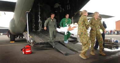 Squadron Leader Steve Cook, back left, a paramedic, Leading Aircraftwoman Hayley Edwards, front left, and Flying Officer (now Wing Commander) Kim Davey carry a Bali bombing victim from a C-130 Hercules. Story by Flight Lieutenant Suellen Heath and Corporal Jacob Joseph. Photo by Sergeant Troy Rodgers.