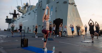 Army Physiotherapist Lieutenant Nicola Hribar leads a sunrise yoga class for members of ship’s company and embarked forces on the flight deck of HMAS Canberra during AUSINDEX 2019. Story by Sergeant Matthew Bickerton. Photo by Leading Seaman Steven Thomson.