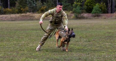 Private Stephen Kennedy and Military Police Dog Razor demonstrating a muzzle strike as one of their capabilities. Story and photo by Captain Thomas Kaye.