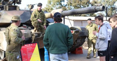 Sergeant Steven Banks, left, and Troopers Nic Spry-Gellert and Oscar Johnson educate students from the Defence Work Experience Program on the M1A1 Abrams main battle tank. Story by Major Carrie Robards. Photo by Trooper Marshall Stanfield.