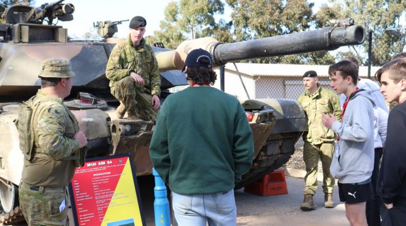 Sergeant Steven Banks, left, and Troopers Nic Spry-Gellert and Oscar Johnson educate students from the Defence Work Experience Program on the M1A1 Abrams main battle tank. Story by Major Carrie Robards. Photo by Trooper Marshall Stanfield.