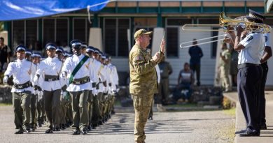 WO1 Mick Beeton, from the 1st Field Regiment Band, leads the Solomon Islands Police Force band during a march-out parade for new recruits in Honiara. Story by Lieutenant Geoff Long. Photo by Corporal Jonathan Goedhart.