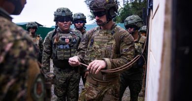 Australian Army soldier Corporal Connor McLeod explains to members of the Armed Forces of the Philippines how to attach a detonator to a breaching charge in the Philippines. Story by Captain Joanne Leca. Photo by Corporal Julia Whitwell.