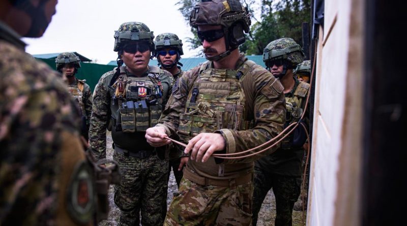 Australian Army soldier Corporal Connor McLeod explains to members of the Armed Forces of the Philippines how to attach a detonator to a breaching charge in the Philippines. Story by Captain Joanne Leca. Photo by Corporal Julia Whitwell.
