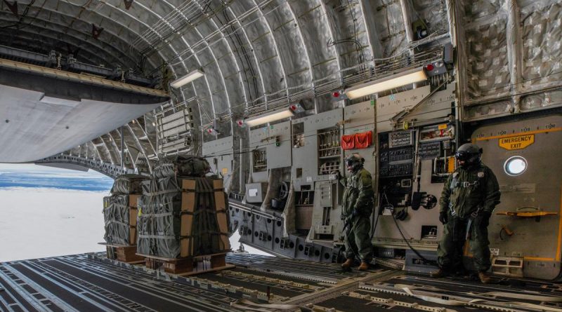 36 Squadron loadmasters Corporal Shaun Harding, left, and Flight Sergeant Rick Haslewood launch essential supplies from a C-17A Globemaster over Casey Station, Antarctica. Story by Flight Lieutenant Suellen Heath. Photo by Corporal Kylie Gibson.