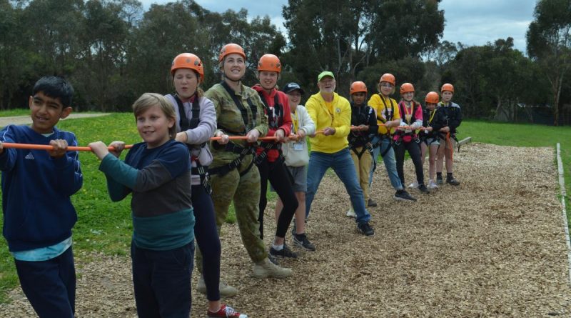 Lieutenant Amber Duncan from the 3rd Health Battalion jumps in to help with the giant swing during the unit's community engagement day with Camp Quality in Camp Mylor, South Australia. Story by Captain Annie Richardson.