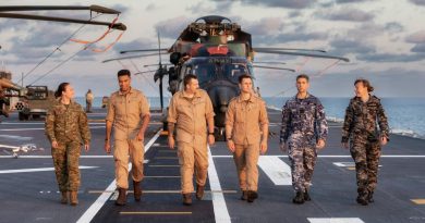 Australian Defence Force and German Navy members walk along the flight deck of HMAS Adelaide during Indo-Pacific Endeavour 2022. Story by Lieutenant Emma Anderson. Photo by Leading Seaman Sittichai Sakonpoonpol.