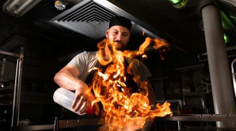 Maritime Logistics Chef Able Seaman Daniel Crowther prepares food in the galley on board HMAS Hobart during a regional presence deployment. Story by Lieutenant Brendan Trembath. Photo by Leading Seaman Daniel Goodman.