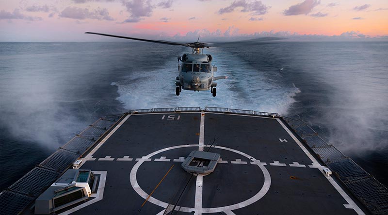 HMAS Arunta’s embarked MH-60R helicopter 'Athena' come in to land as the ship transits through the Indonesian archipelago during a regional presence deployment. Photo by Able Seaman Susan Mossop.
