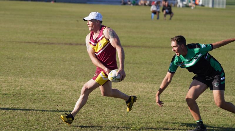 ACT/NSW Country’s Squadron Leader Danny Bretherton, left, works hard to evade the desperate defence of North Queensland’s Corporal Andrew Cooper. Story by Squadron Leader Peter Croce. Photo Supplied.