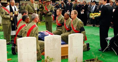 Australian Army personnel ready to take up the Australian flag from the coffin of Australian WWI soldiers being re-interred in Belgium. The soldiers were finally laid to rest after being thought missing for 90 years. Story by Corporal Jacob Joseph. Photo by Corporal Chris Moore.