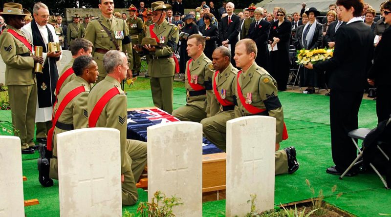 Australian Army personnel ready to take up the Australian flag from the coffin of Australian WWI soldiers being re-interred in Belgium. The soldiers were finally laid to rest after being thought missing for 90 years. Story by Corporal Jacob Joseph. Photo by Corporal Chris Moore.
